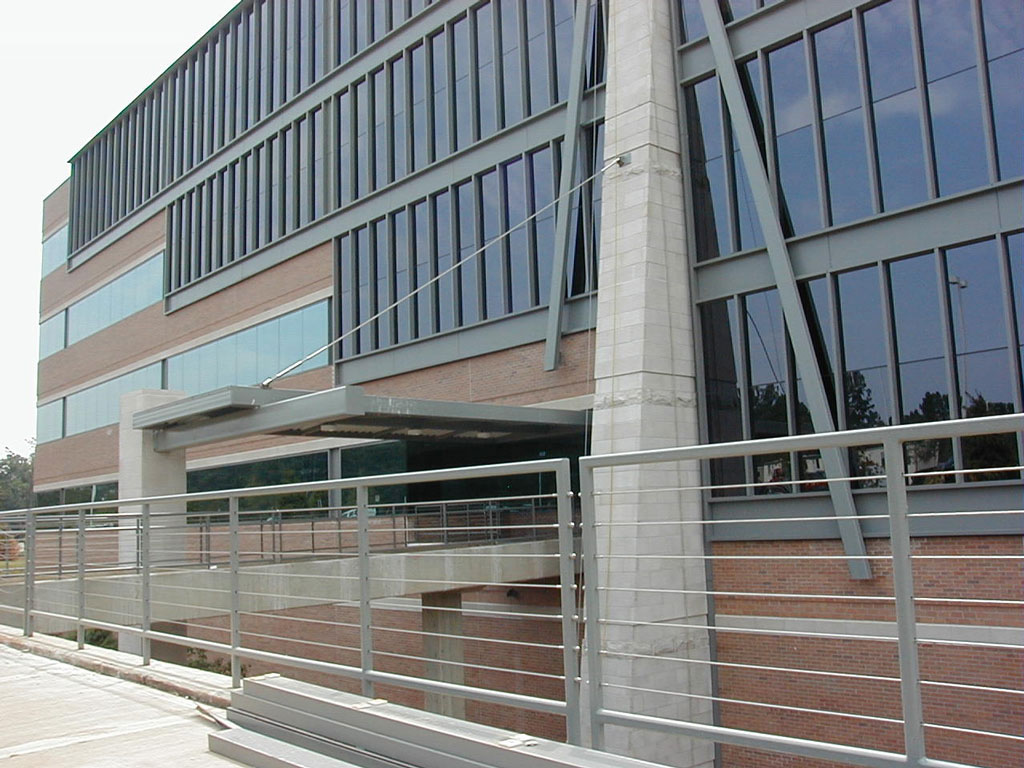 A building with glass windows and concrete railings.